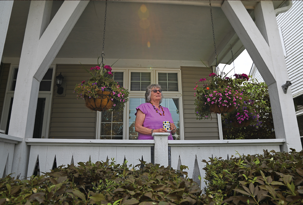 Sue Crawford on the covered porch of her home