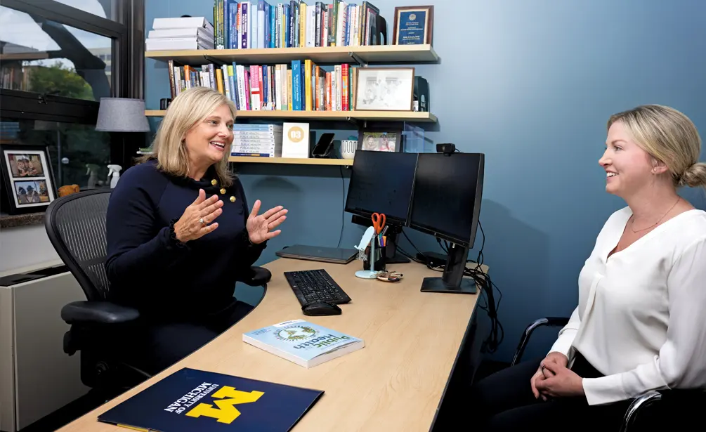 Emily Youatt, left, with Jillian McConville at a desk.