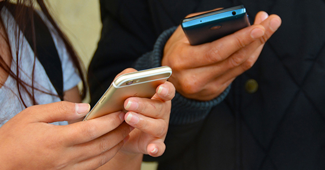 people using cell phones to browse social media