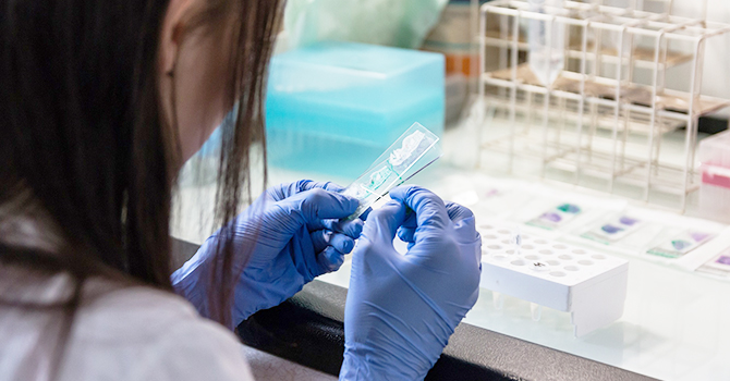 Woman in lab with slide