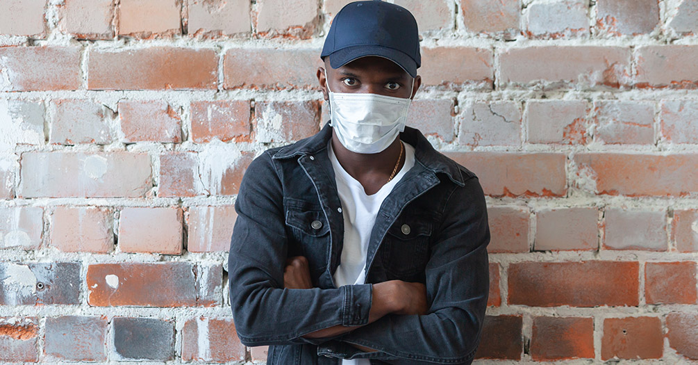 An African American man wearing a mask.