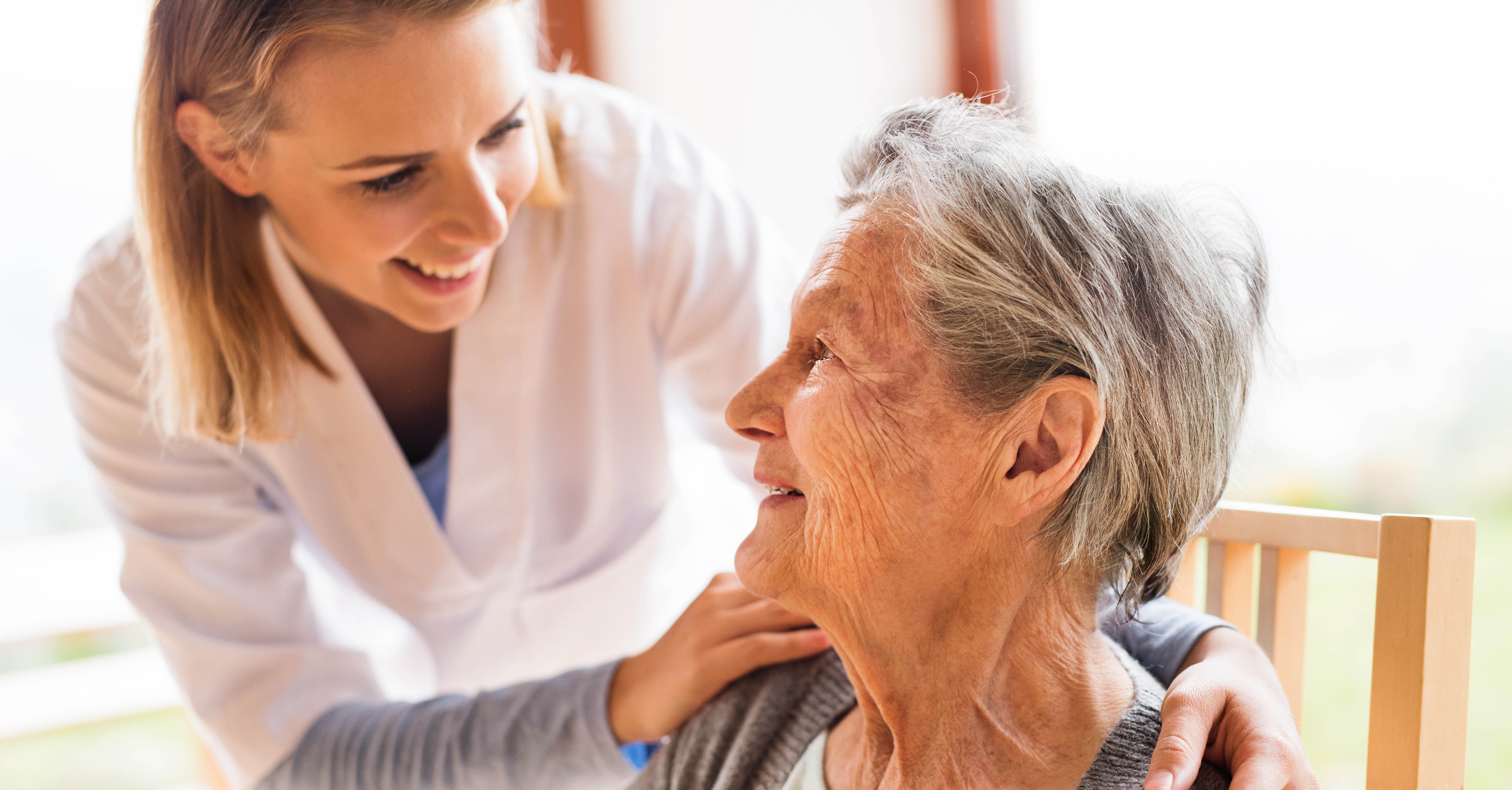 A nurse cares for an elderly patient.