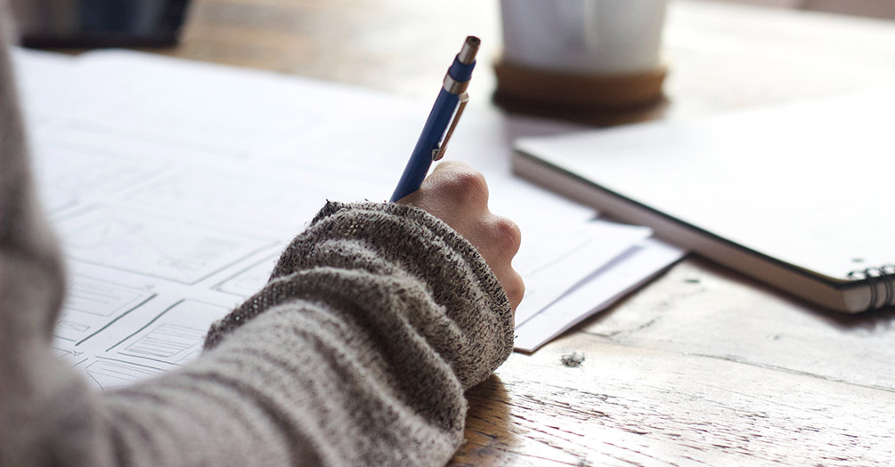 A student writing in a notebook.