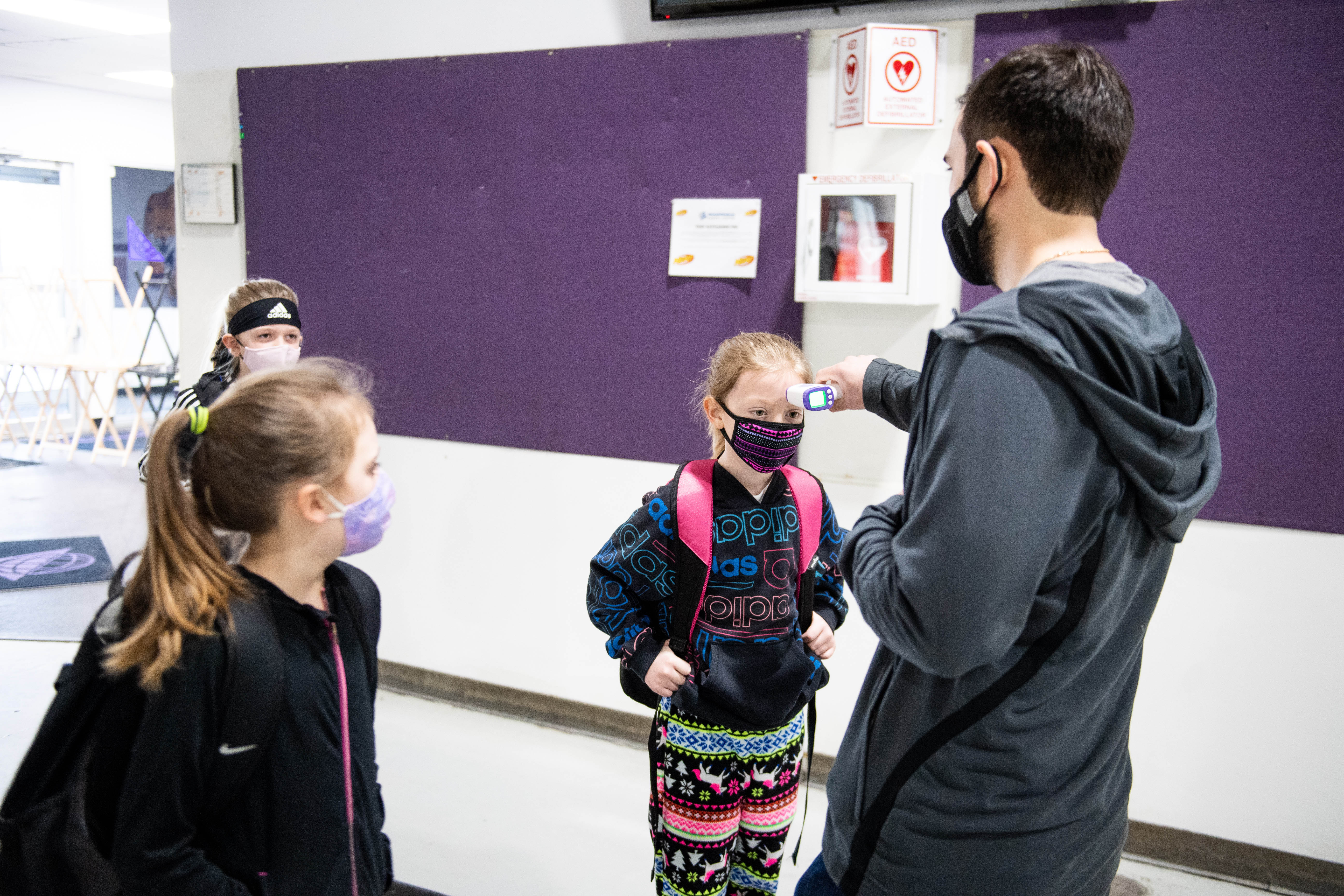 Players get a temperature check before practice.