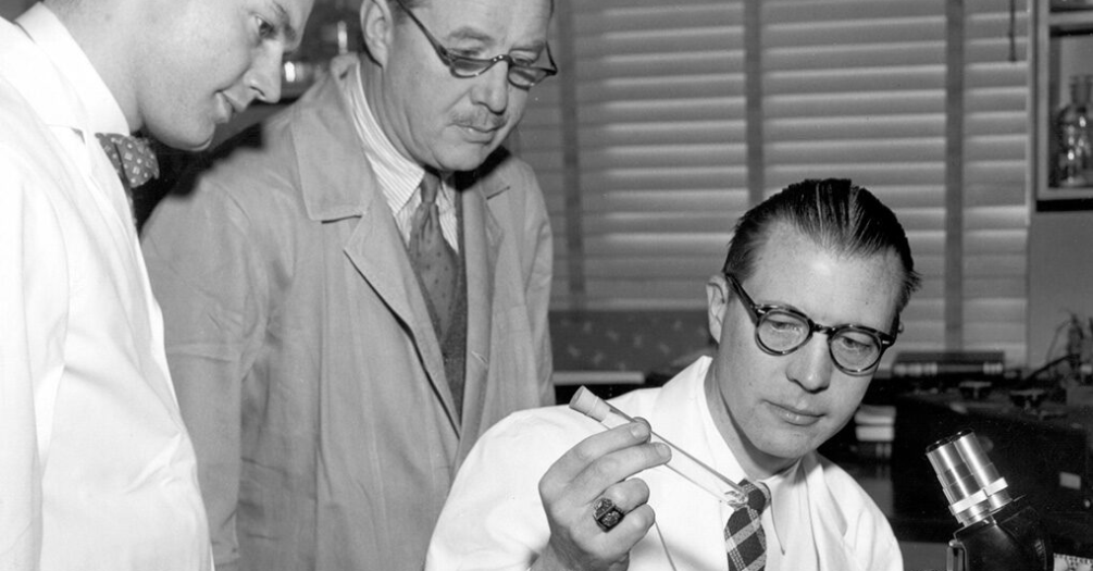 Thomas Francis examines a culture with fellow scientists Wilbur Ackerman and Gordon Brown.