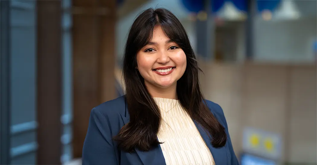 Chloe Thach with a blue blazer and a white sweater underneath at the School of Public Health